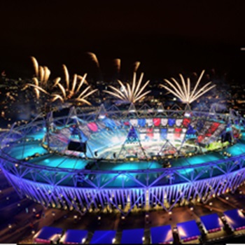 Stadium lit up at night with firework display taking place