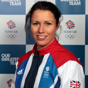 Headshot of Annie Panter. A white woman with dark hair, smiling. Dressed in Team GB kit.
