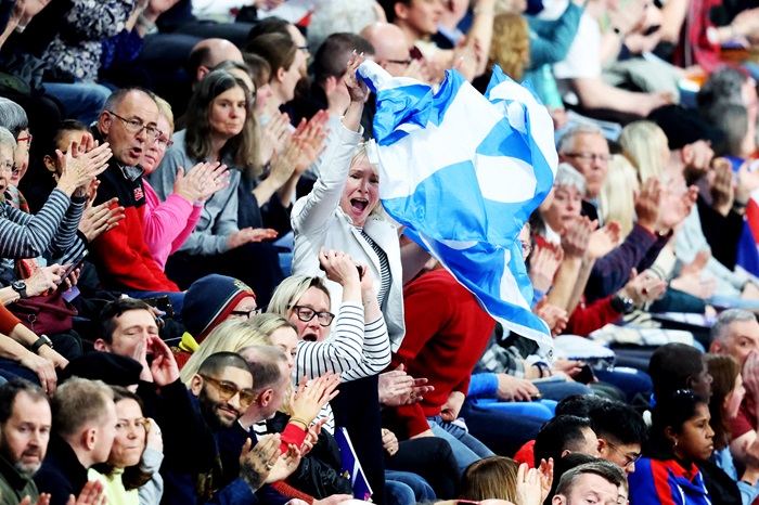 A Scottish fan waves the country's flag cheering on athletes at the 2024 Indoor World Athletics Championships.