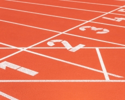 Close up photograph of the start line of an athletics track