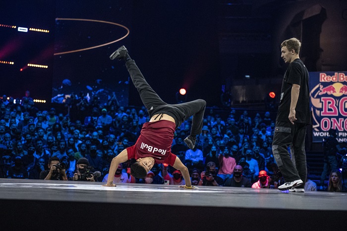 bboy dancer upside down with his legs inthe air competing 