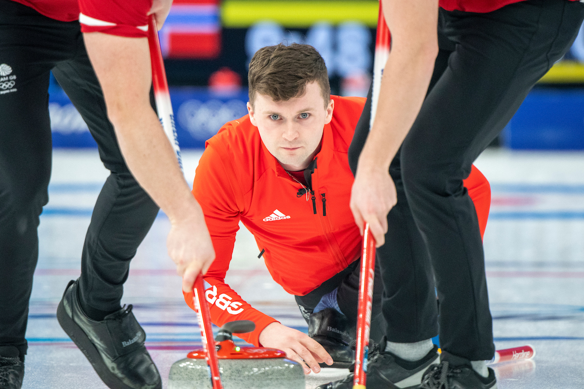Bruce pushing the stone on the rink