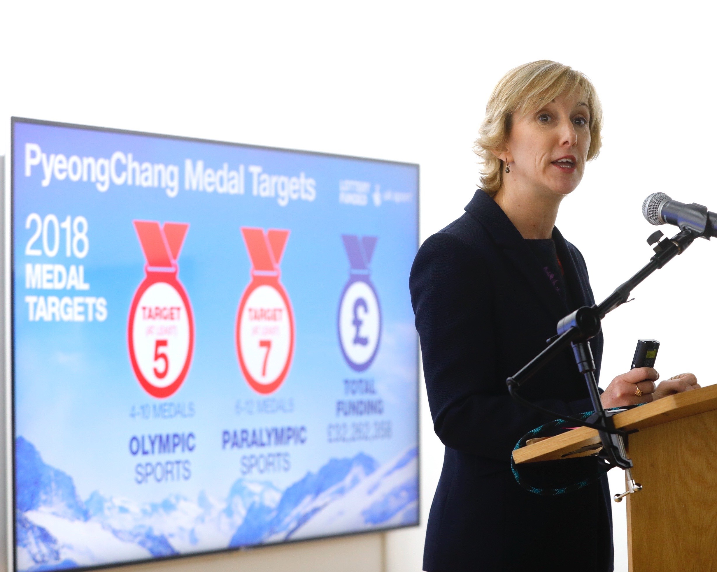 Chelsea Warr stood at a lectern delivering a presentation 