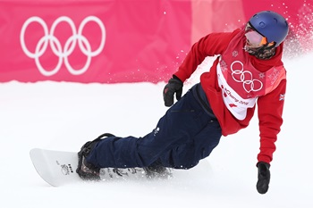 A snowboard athlete competing in an event at the Winter Olympics