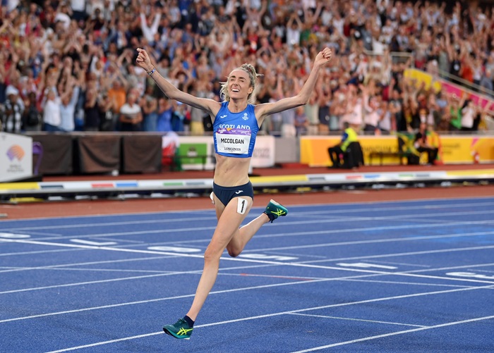 Eilish crossing the line celebrating with her arms in the air