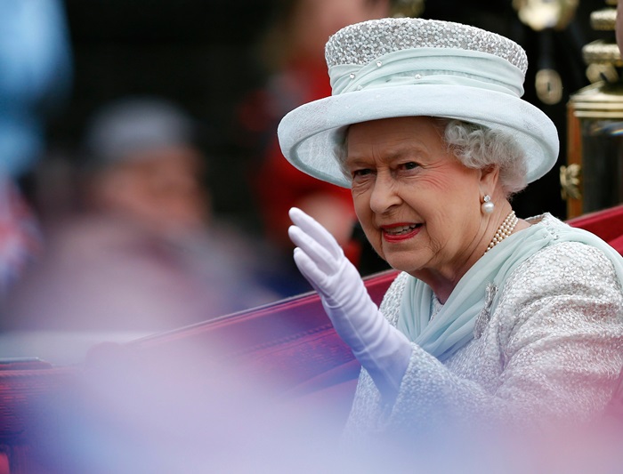 Queen Elizabeth II waving from her car