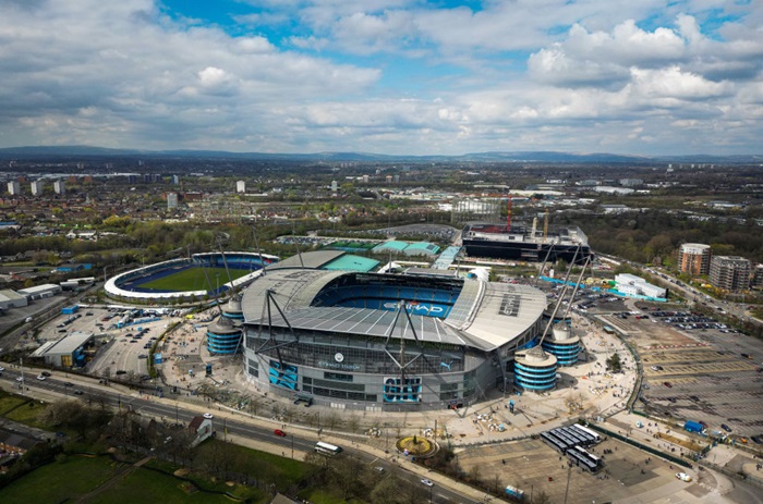 An aerial view of Manchester City Stadium, Regional Arena (Athletics), Tennis and Squash Centre, and the Co-op Arena being built.