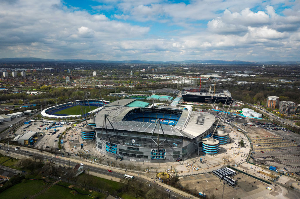 An aerial view of Manchester City Stadium, Regional Arena (Athletics), Tennis and Squash Centre, and the Co-op Arena being built.