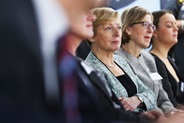 Liz Nicholl pictured at a conference watching the speakers, and listening on.