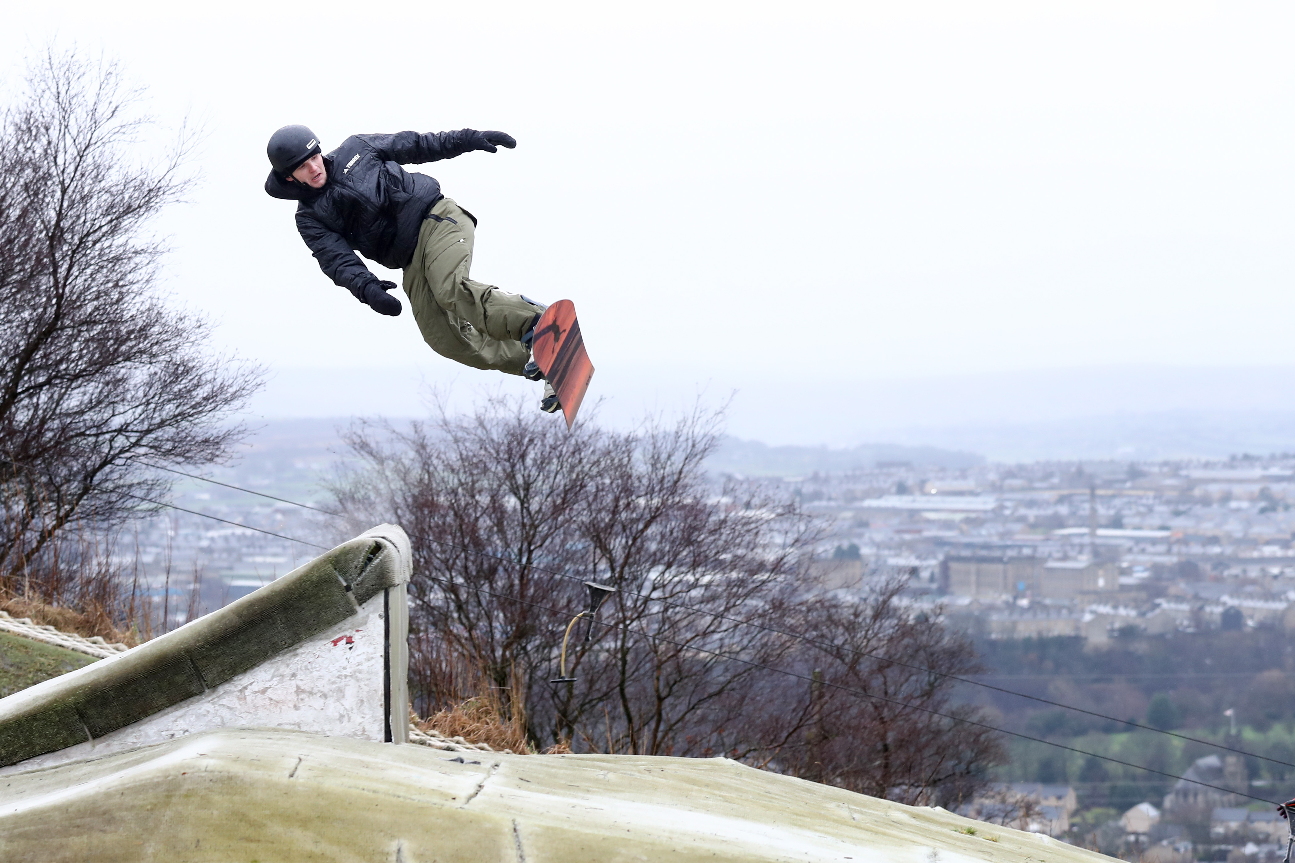 Halifax dryslope with snowboarder in the air from a jump