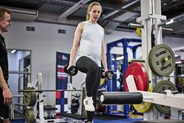athlete in the gym pregnant working out with weights