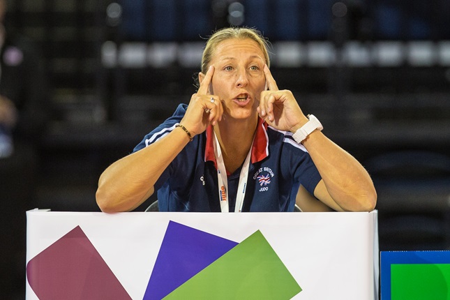 Kate holding giving guidance in competition