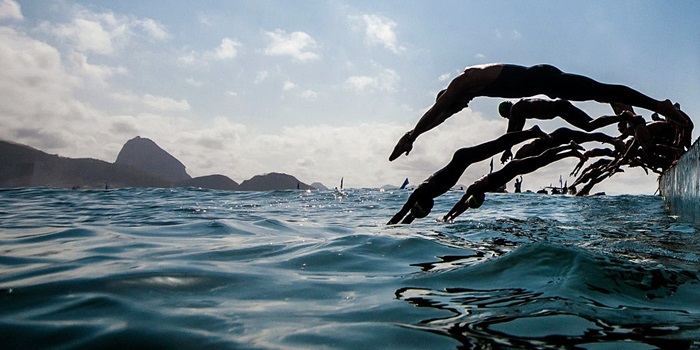 Swimmers diving into the sea