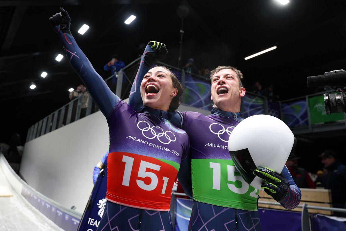 Two athletes for Team Great Britain acknowledge the fans after winning the gold medals.