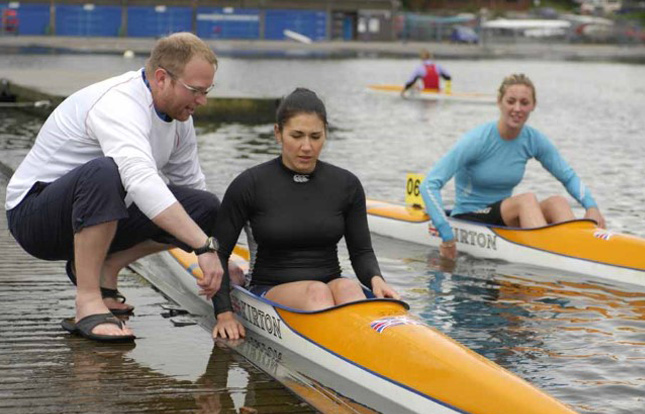 A coach training a canoe athlete