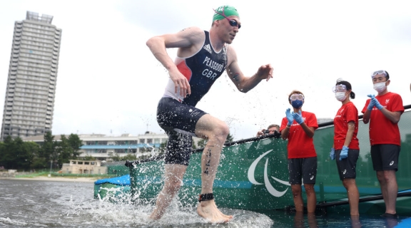 Peasgood running out of the water into the transition at Tokyo