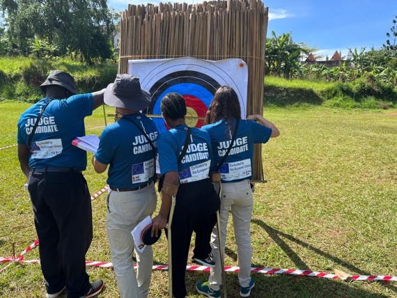 ParaArchery coaches standing around a target