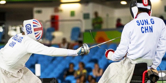 Athletes competing in wheelchair fencing