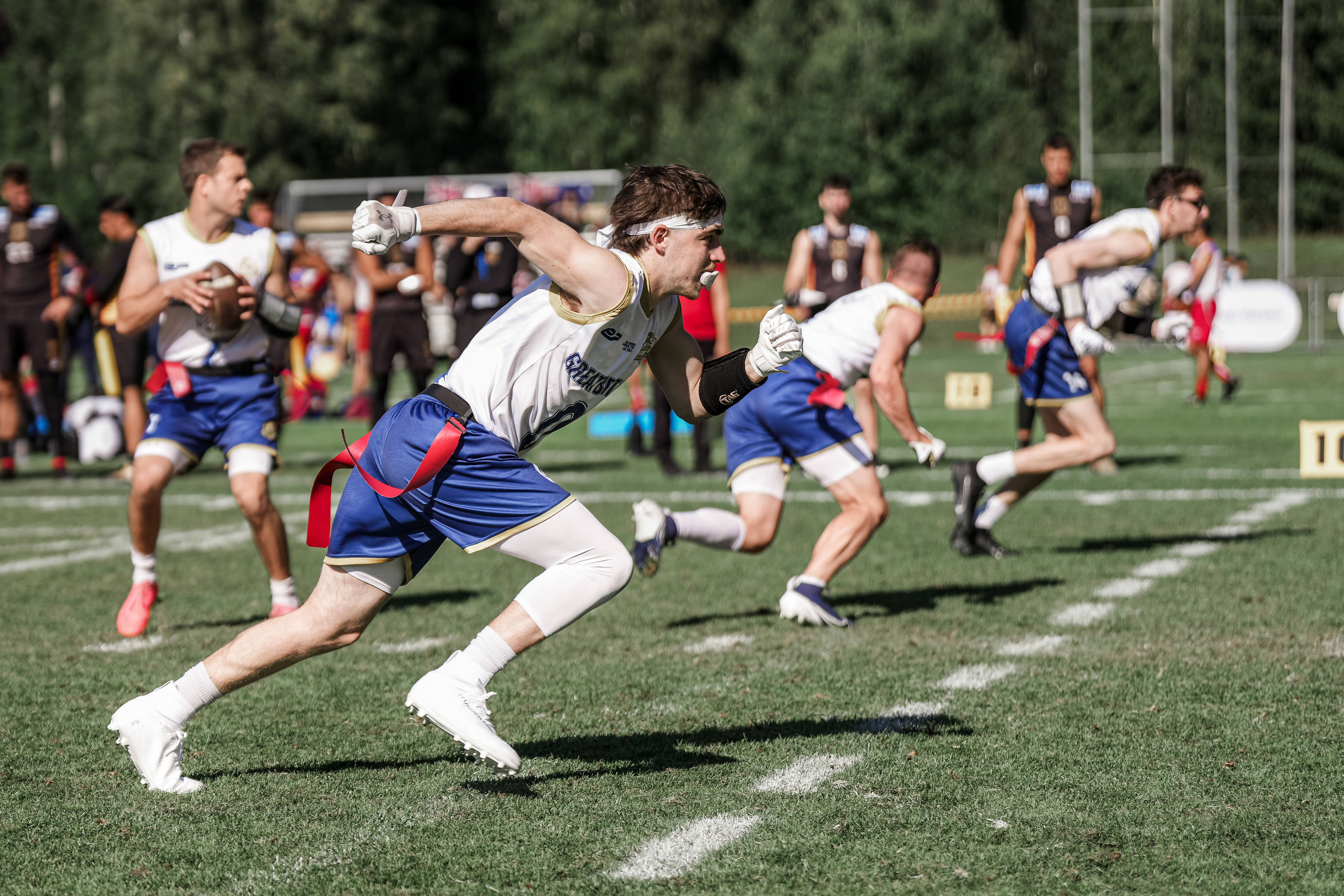 GB Men vs Germany, flag football, a player runs as the quarterback prepares the throw.