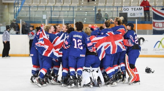 GB Ice Hockey Team celebrating in a group at the end of an ice hockey match