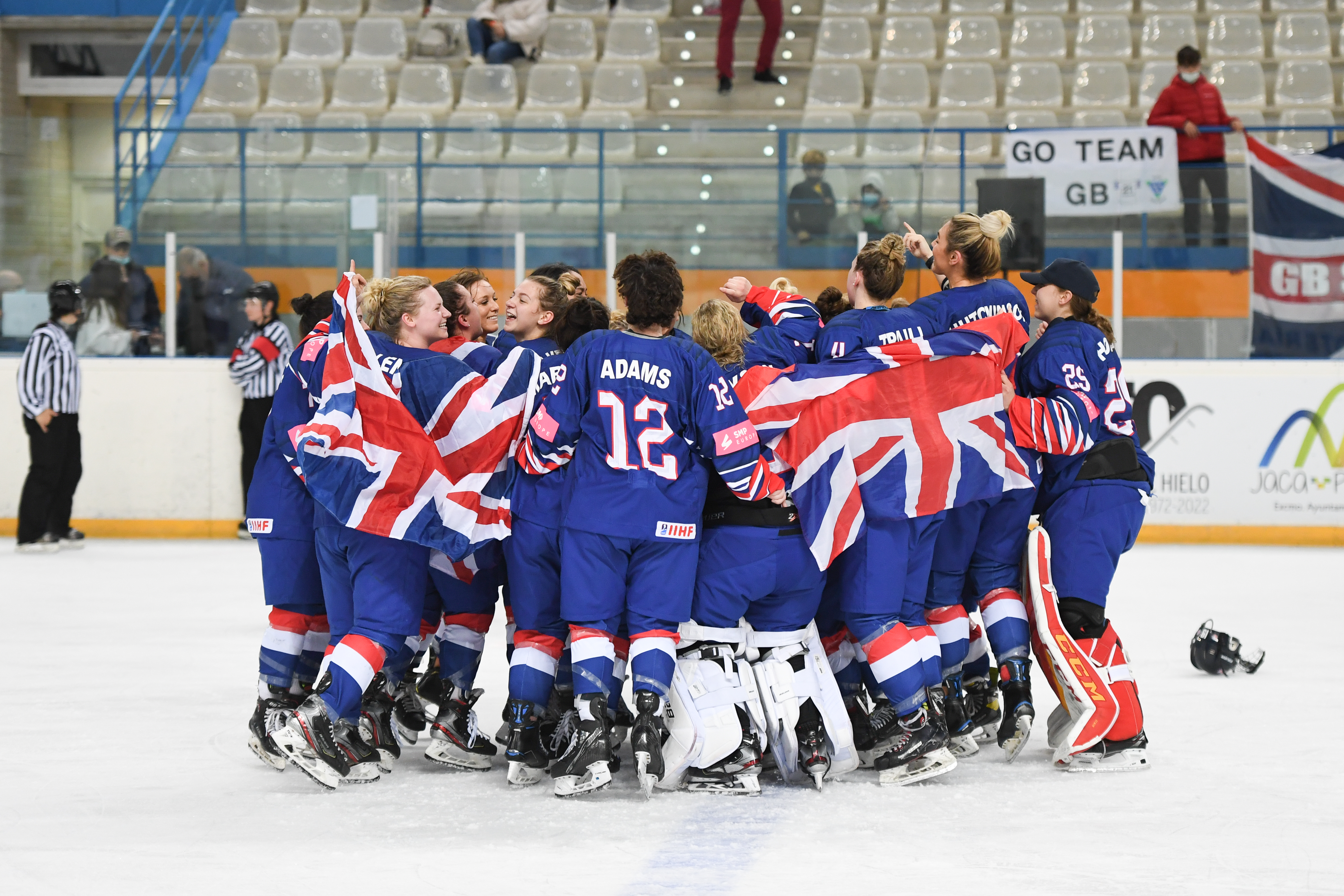 GB Ice Hockey Team celebrating in a group at the end of an ice hockey match