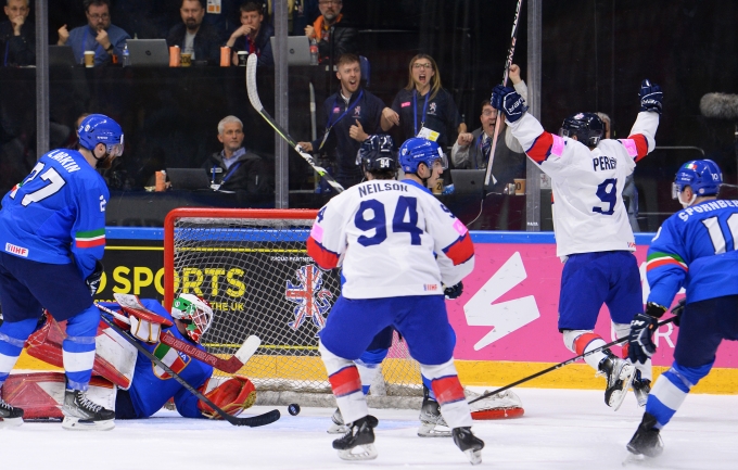 GB Ice Hockey Team competing in an ice hockey match and celebrating after scoring