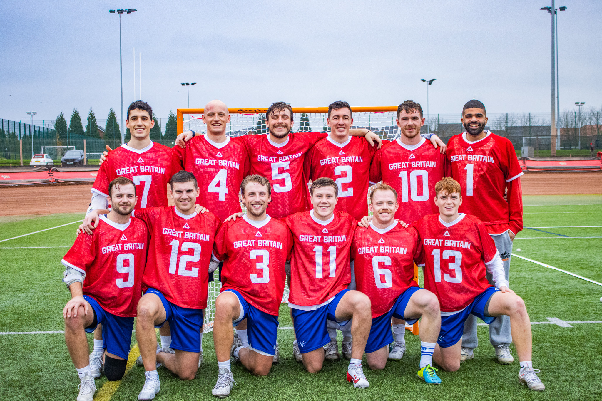 British Men's Lacrosse stand in row after a match to pose for the camera.