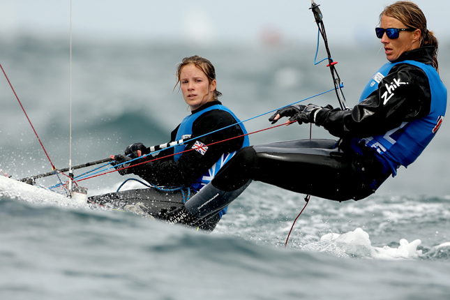 Two athletes competing in sailing event