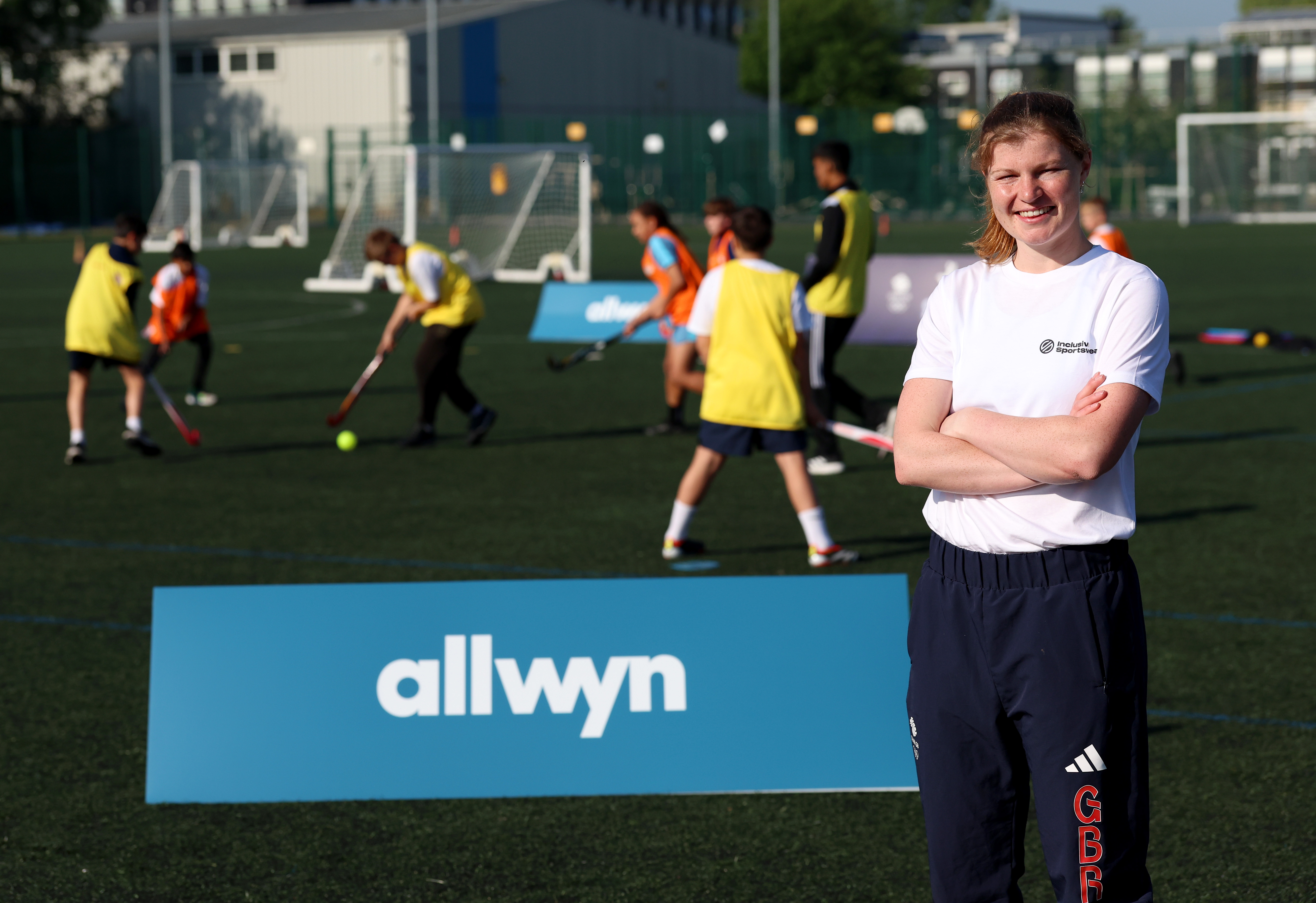 Tess Howard standing in front of a banner saying 