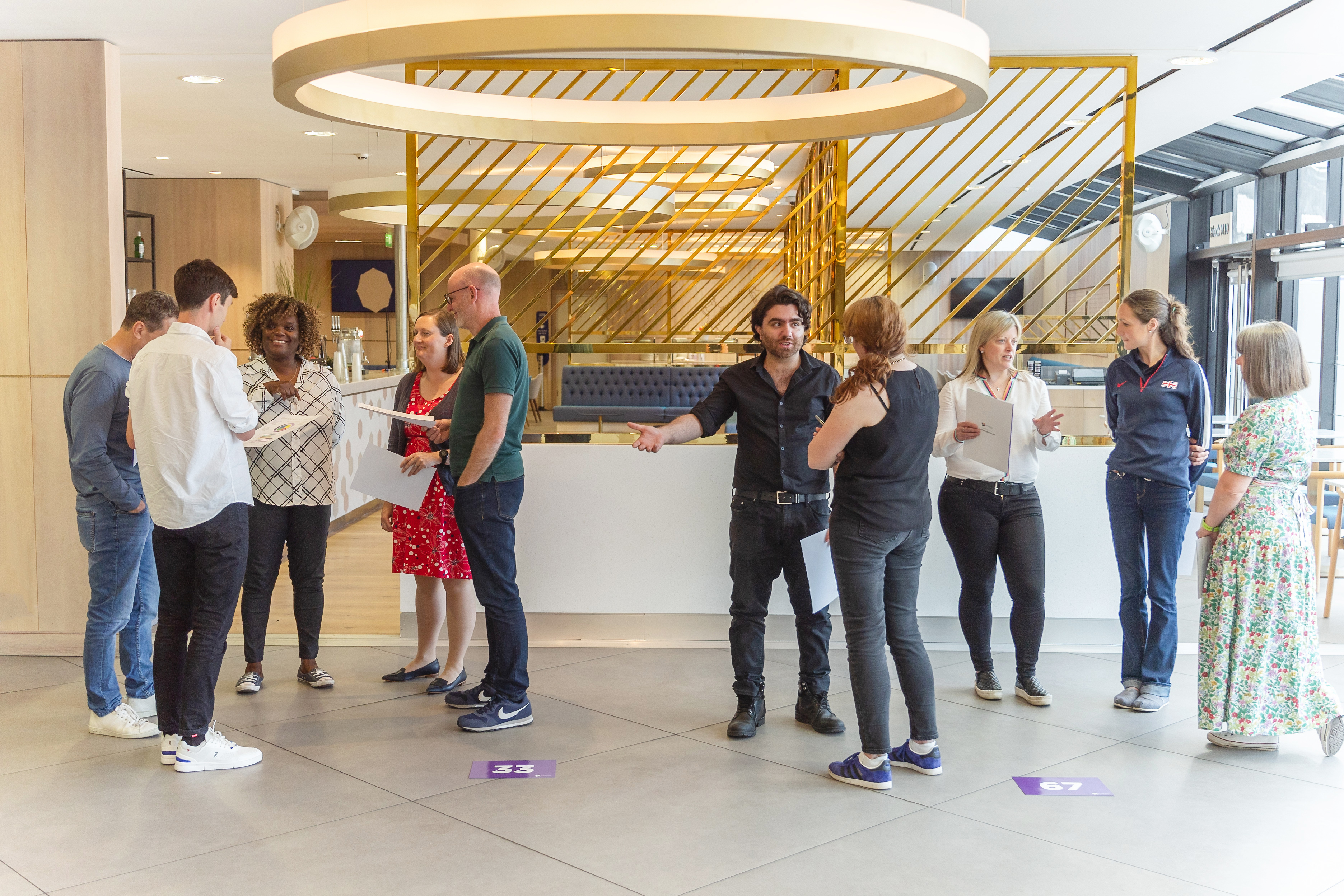 A group of people, the eleventh cohort of the UK Sport International Leadership Programme take part in the module one, in discussion at London Stadium, Stratford, London.