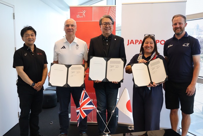 Representatives from UK Sport, The Japan Sport Council, and the UK Sports Institute display the Memorandum of Understanding.