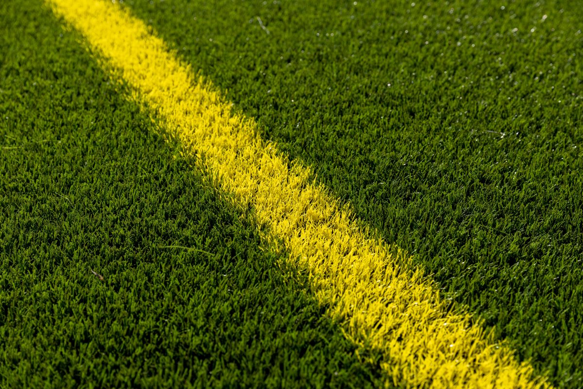 Astroturf with a yellow line across it diagonally.