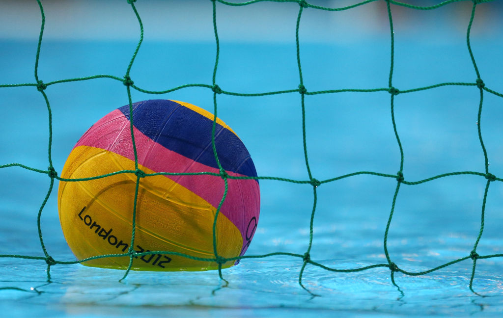 Waterpolo ball floating in the water behind the net