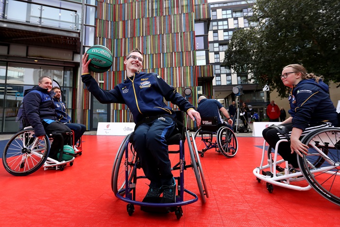 Leeds rhinos wheelchair basketball player catching the ball with one hand at a media event in leeds