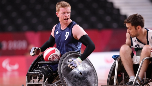 Athlete in a wheelchair competing in a wheelchair rugby match